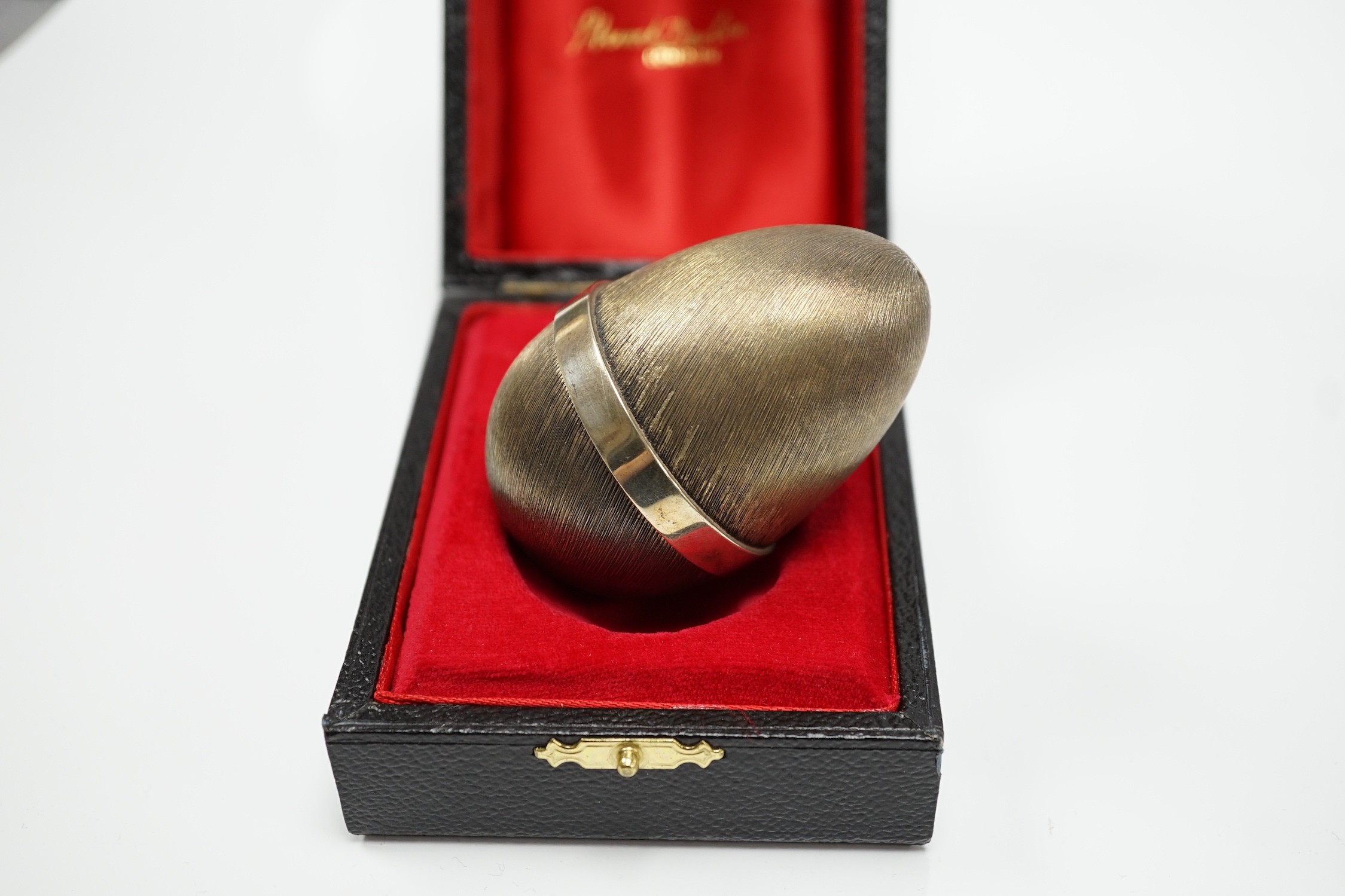 An Elizabeth II Stuart Devlin silver gilt surprise egg, opening to reveal a hedgehog, no. 152, London, 1978, 7cm, in original box.